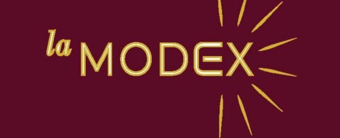 La MODEX gold logo on burgundy background