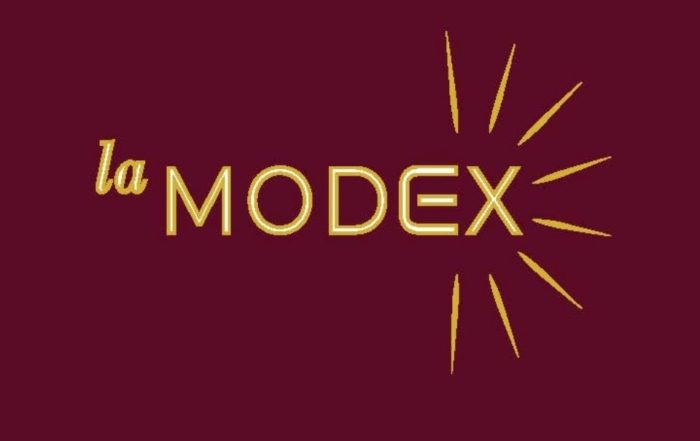 La MODEX gold logo on burgundy background